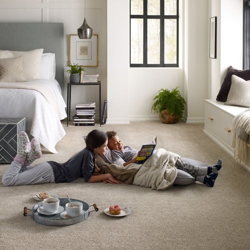 people reading a book laying on the floor from Wilkins Carpet and Tile Center in Taylors